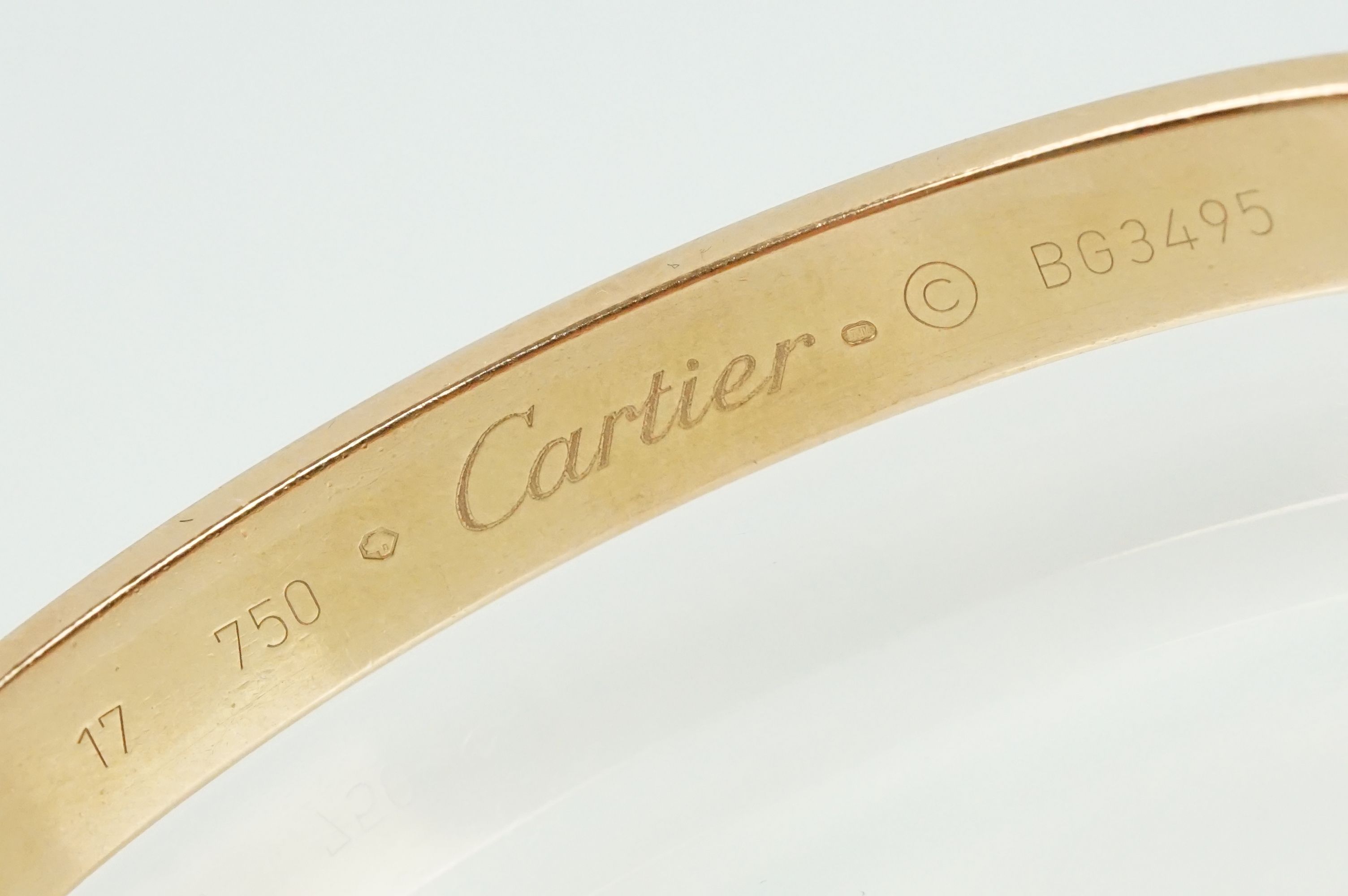 Cartier - 18ct gold 'love' bangle bracelet of oval form with screw detailing. Signed Cartier with - Image 7 of 11