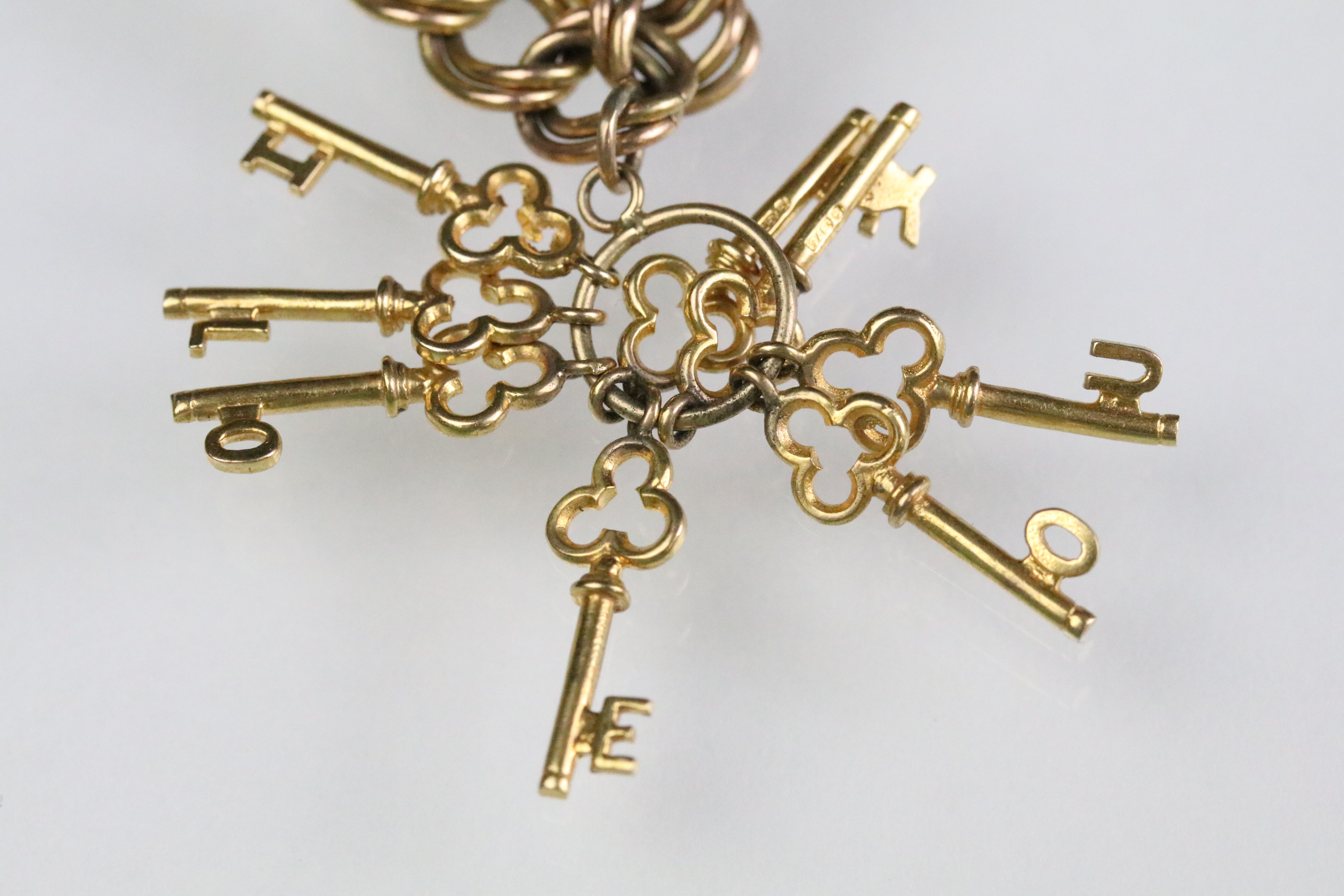 9ct gold hallmarked charm bracelet. The double curb heart lock bracelet mounted with five 9ct gold - Image 10 of 13