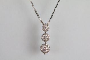 Three stone diamond pendant being set with three round brilliant cut diamonds each with a halo of