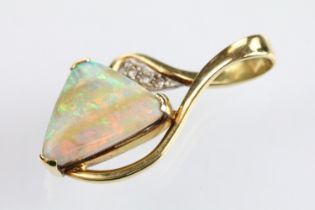 18ct gold opal and diamond pendant being set with a polished triangular opal displaying a full