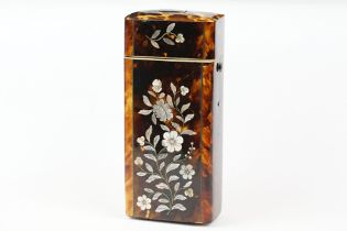 An early 20th century tortoiseshell spectacle case with mother of pearl floral decoration.
