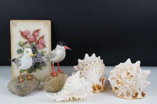 Three seashells to include conch shells, plus two wooden models of seabirds, and a floral wall