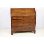 George III mahogany bureau, the fall front opening to reveal an arrangement of cubby holes and