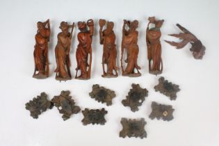 A collection of Chinese carved wooden figures with wooden bases.