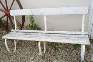 White painted slatted garden bench raised on three wrought iron supports, approx 152cm wide