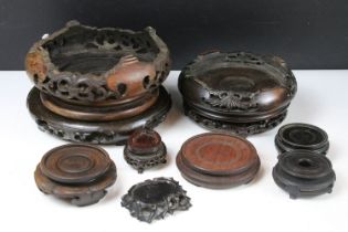 Collection of Oriental hardwood stands to include pierced examples, largest approx 20cm diameter