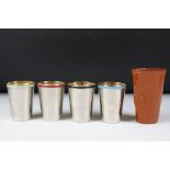 Set of four stacking silver plate & Harlequin enamel stirrup cups with gilt lined interiors,