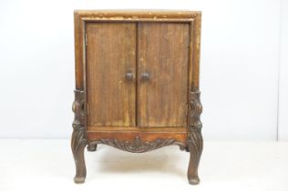 Continental carved record storage cabinet, with ejector buttons, holding a number of 78s, 68cm