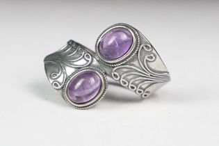 A ladies silver double amethyst cabochon dress ring, marked 925 to the inner shank.