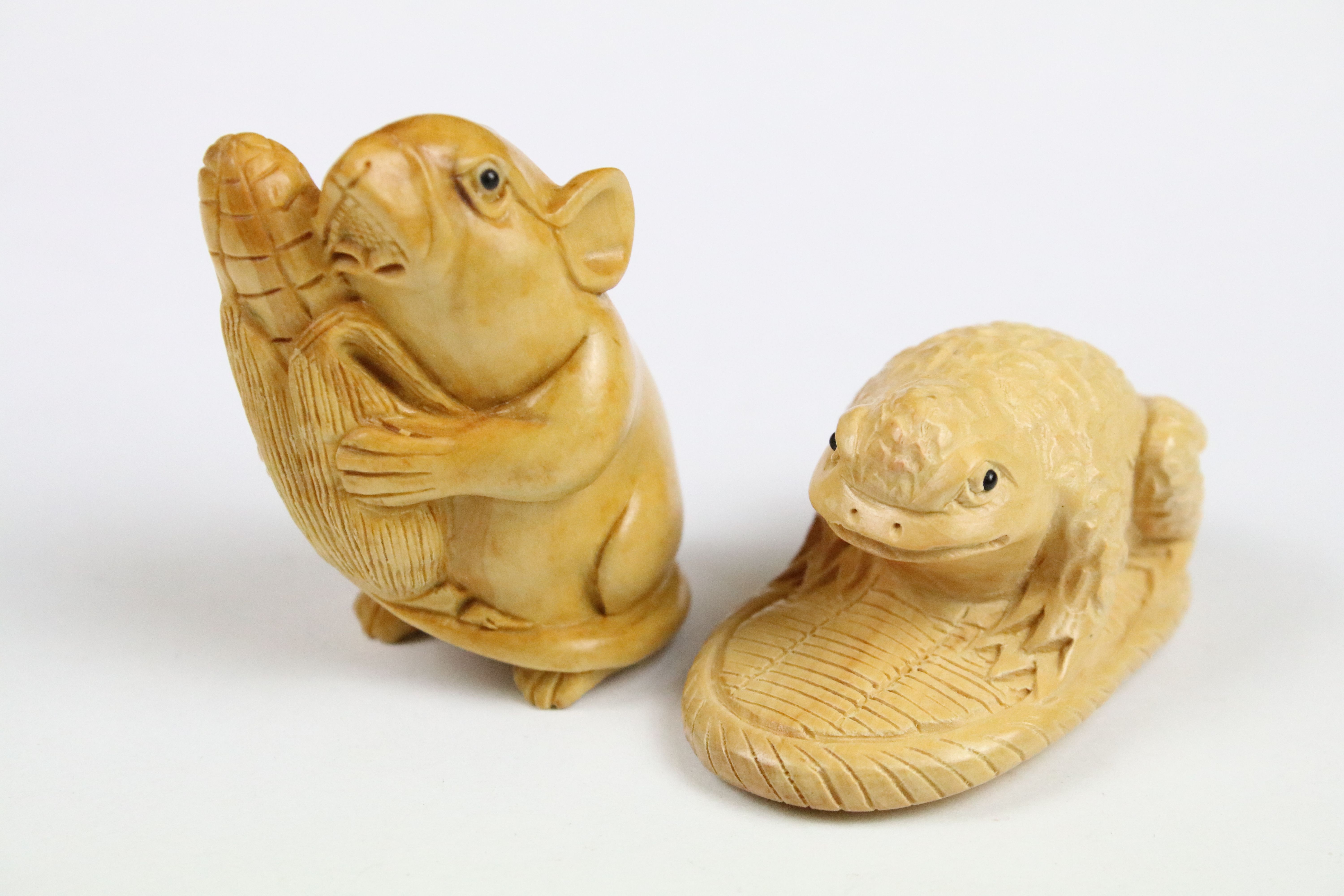 Two carved oriental Netsuke in the form of a Frog and a Mouse.