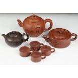 Chinese terracotta Yixing tea ware to include a teapot with four small matching tea cups, teapot