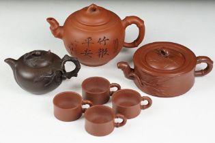 Chinese terracotta Yixing tea ware to include a teapot with four small matching tea cups, teapot