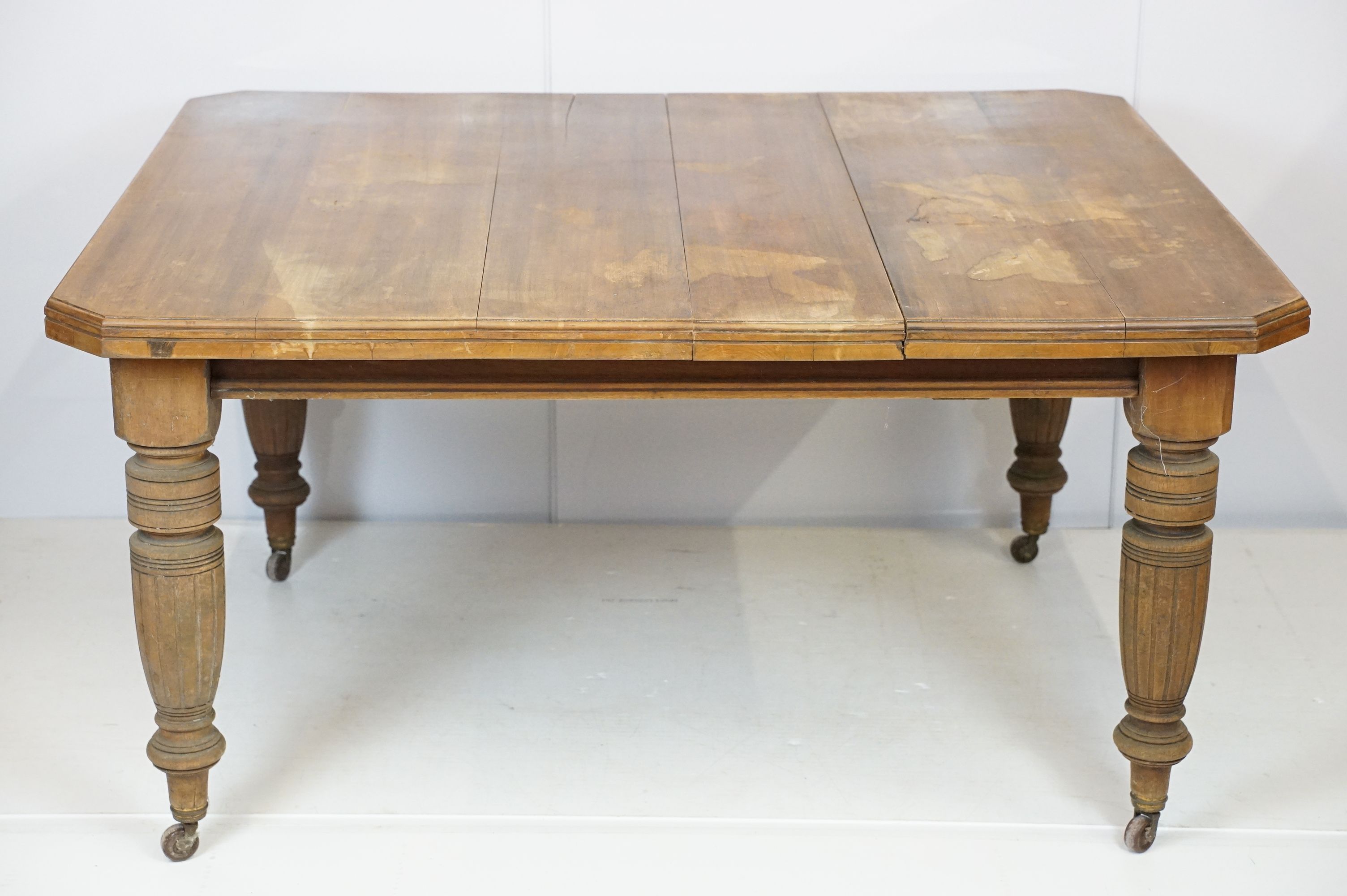 Early 20th century mahogany draw leaf dining table of rectangular form with canted corners on turned