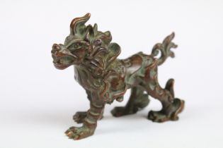 A Chinese bronze ornamental lion in the traditional form