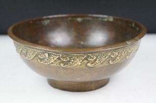Chinese bronze bowl of circular form, with a band of repeating decoration in relief, approx 24.5cm