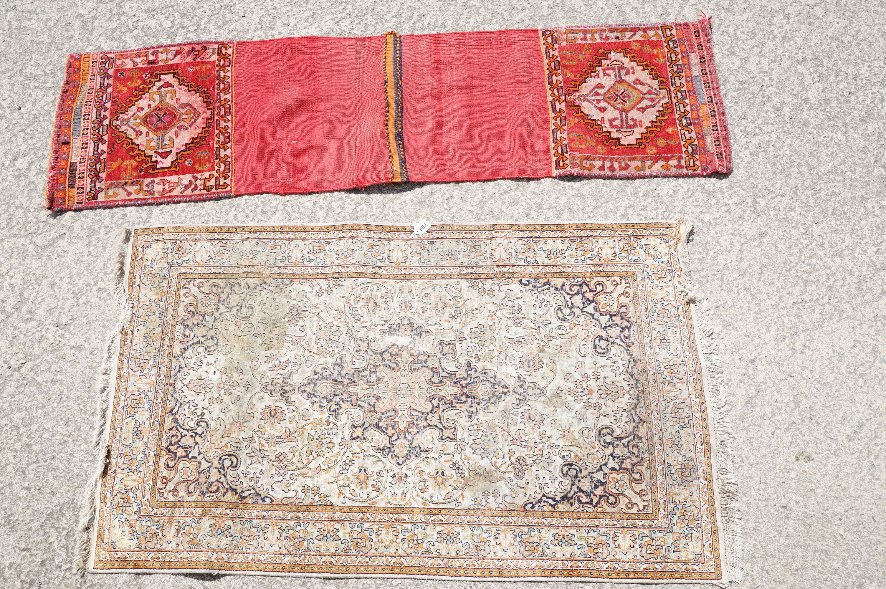 Middle Eastern cream ground carpet, with central stylised motif within geometric borders, 160 x 92cm