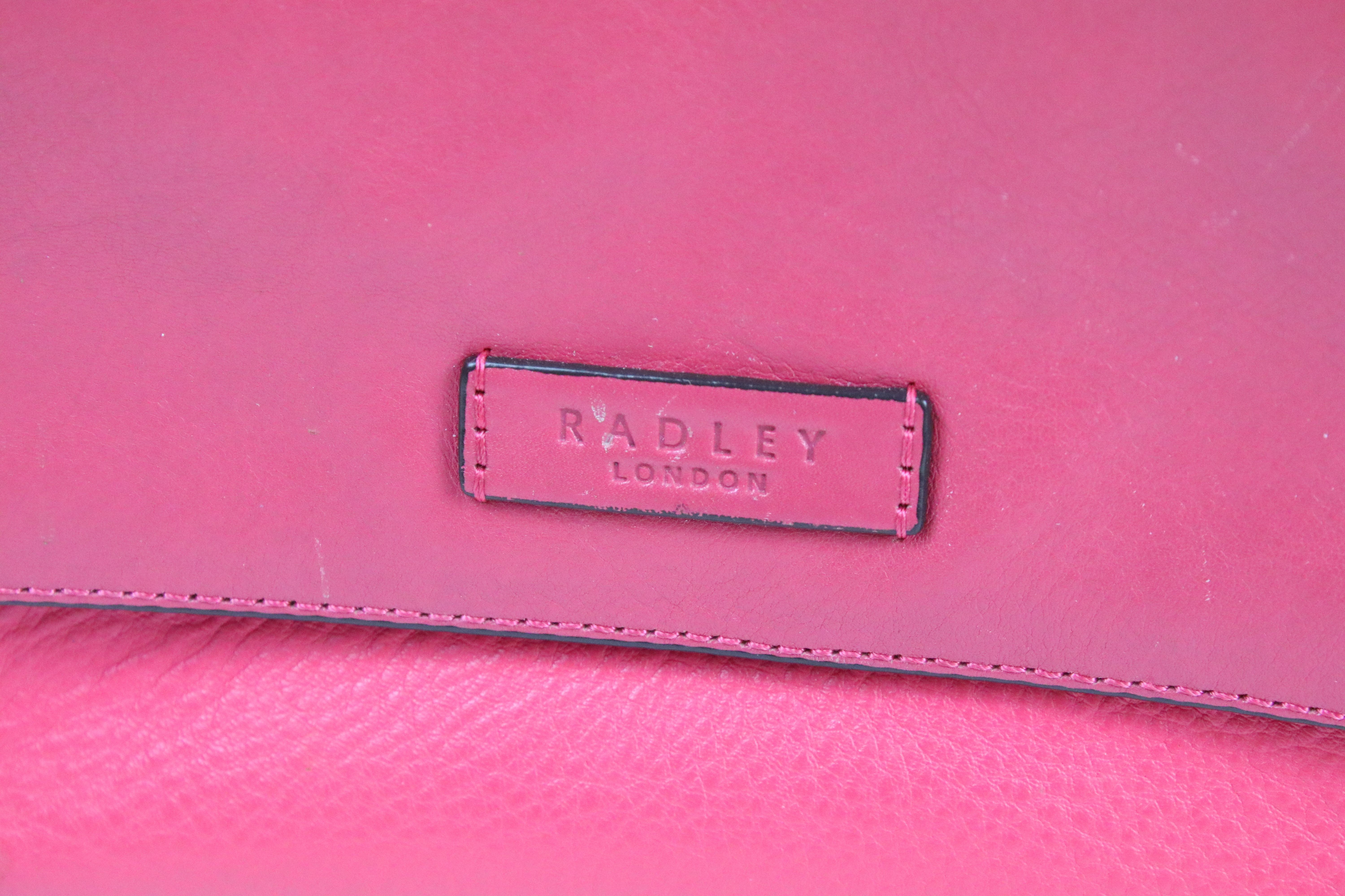 Two Radley handbags to include a black leather handbag and a pink example, both housed within pink - Image 8 of 9