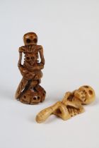 Two carved Netsuke in the the form of skeletal figures.