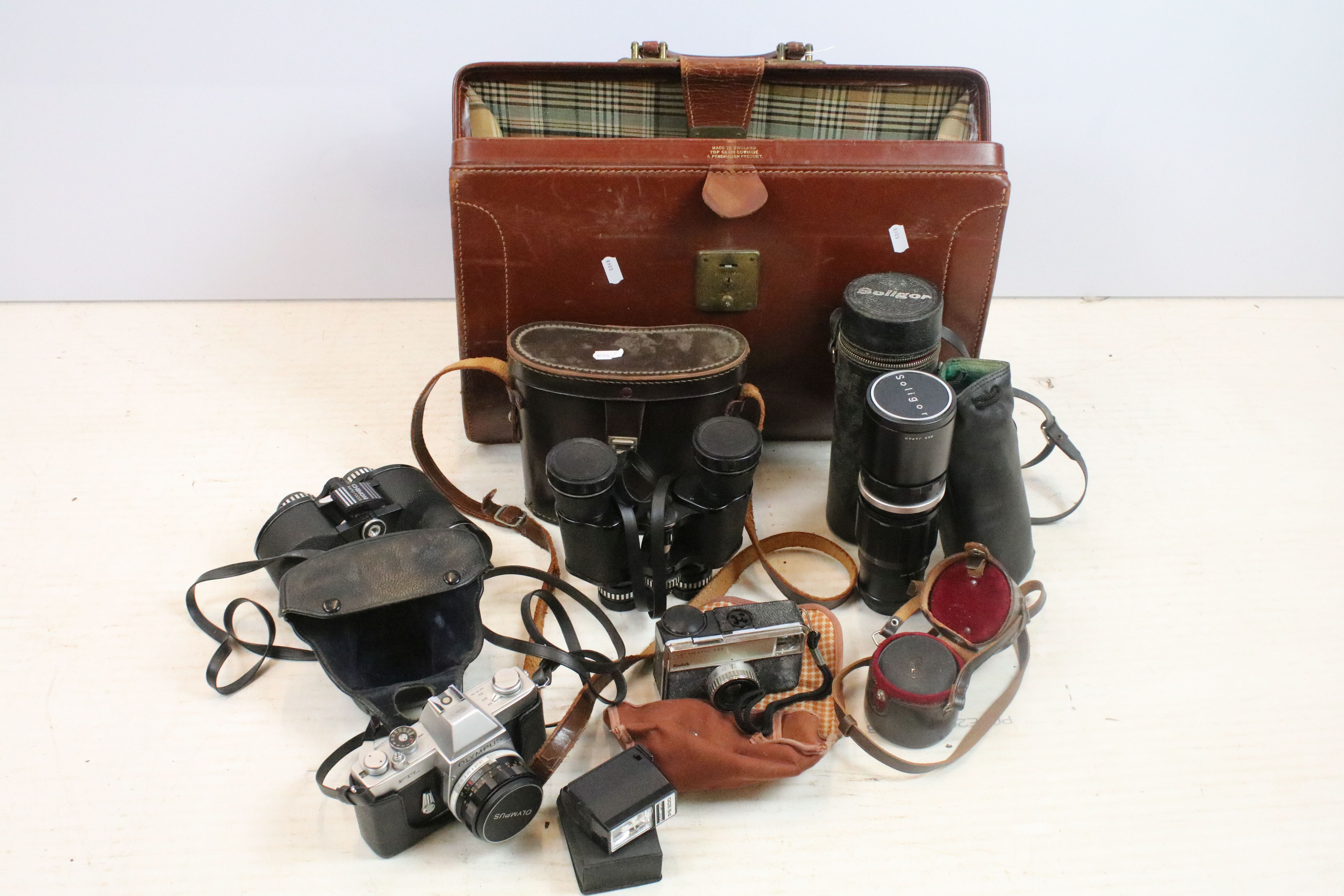 Collection of cameras, lenses & binoculars within a leather case, the lot featuring Olympus FTL (