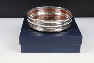 A fully hallmarked sterling silver bottle coaster, assay marked for Birmingham.