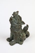 A Chinese bronze ornamental seated foo dog.