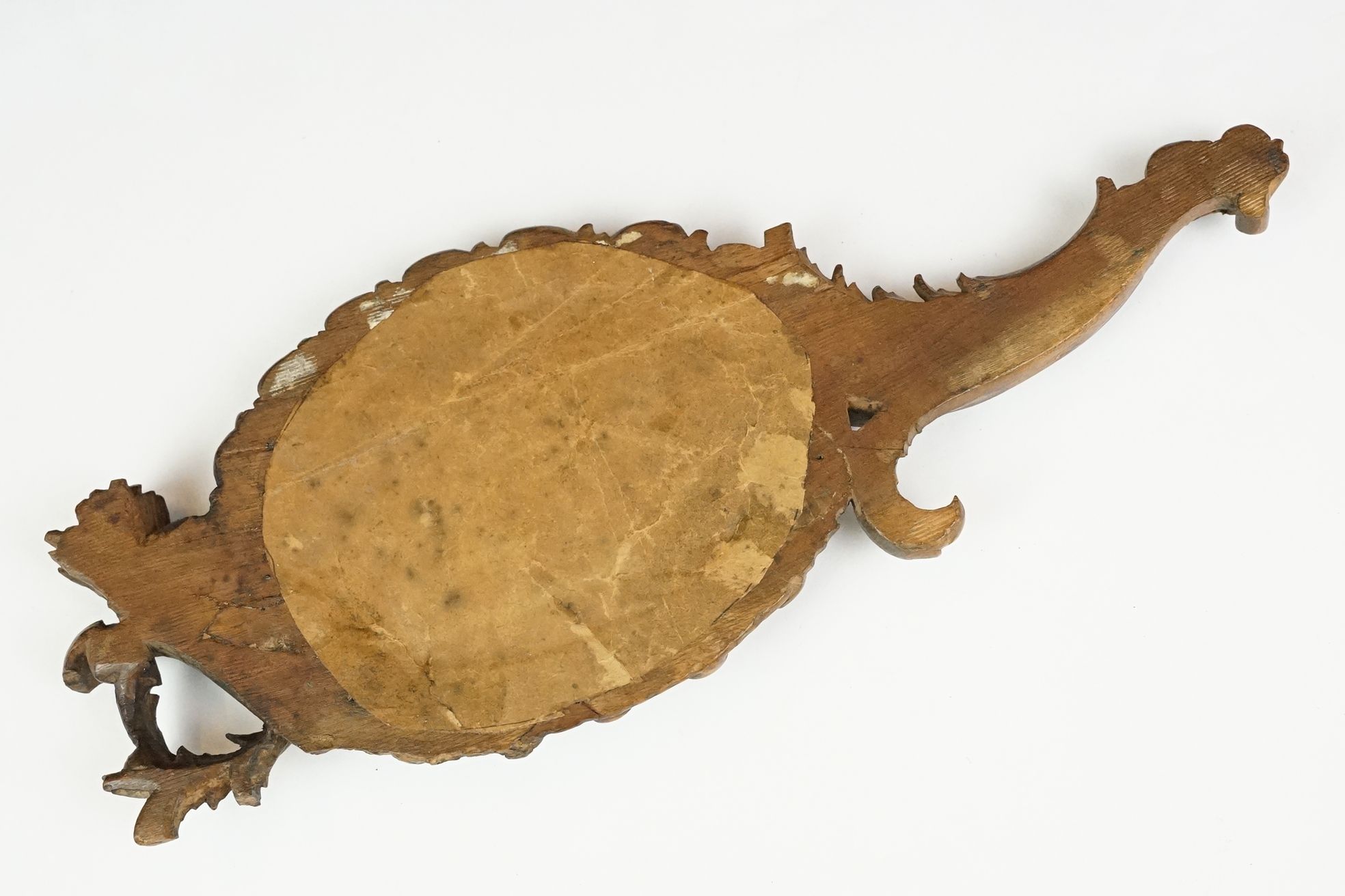 An antique carved wooden Black Forest hand mirror with foliate decoration. - Image 5 of 5