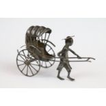 Chinese silver man pulling a rickshaw
