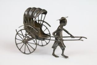 Chinese silver man pulling a rickshaw