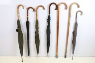 Group of eight vintage umbrellas & walking sticks to include early-to-mid 20th century examples,