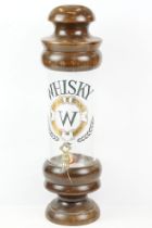 Glass & wooden whisky drinks dispenser, raised on a turned wooden foot, approx 38cm tall