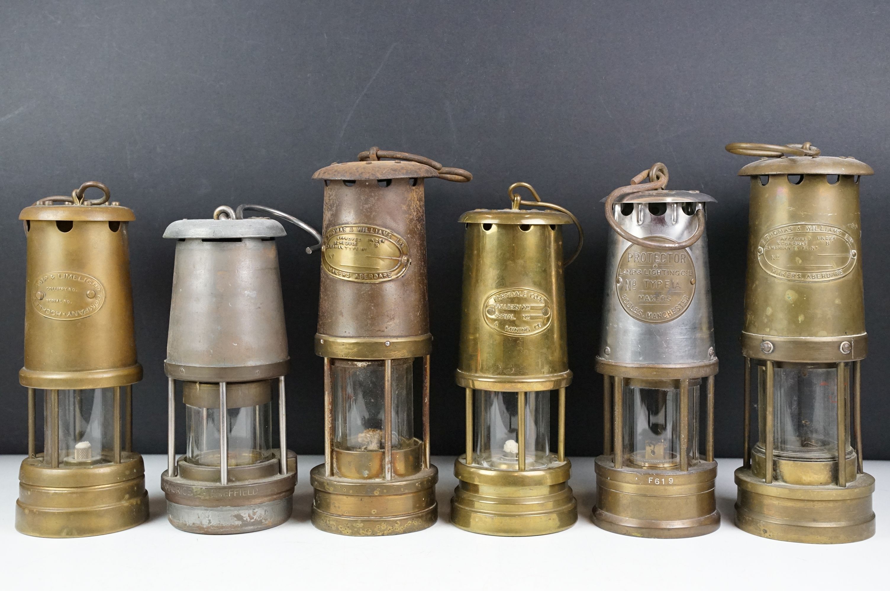 Group of six miners lamps to include E. Thomas & Williams Ltd, Ferndale Coal & Mining Co., The