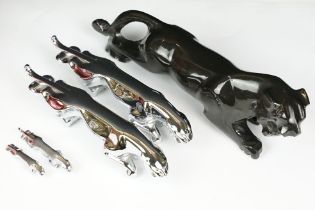 Two chrome jaguar car mascots, together with two miniature chrome jaguars and a black resin