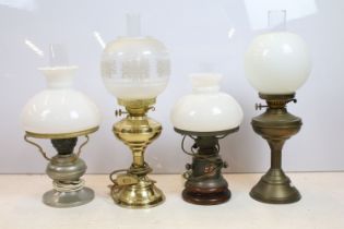 Group of four 20th century oil lamps, three converted to electric, the other being a brass oil