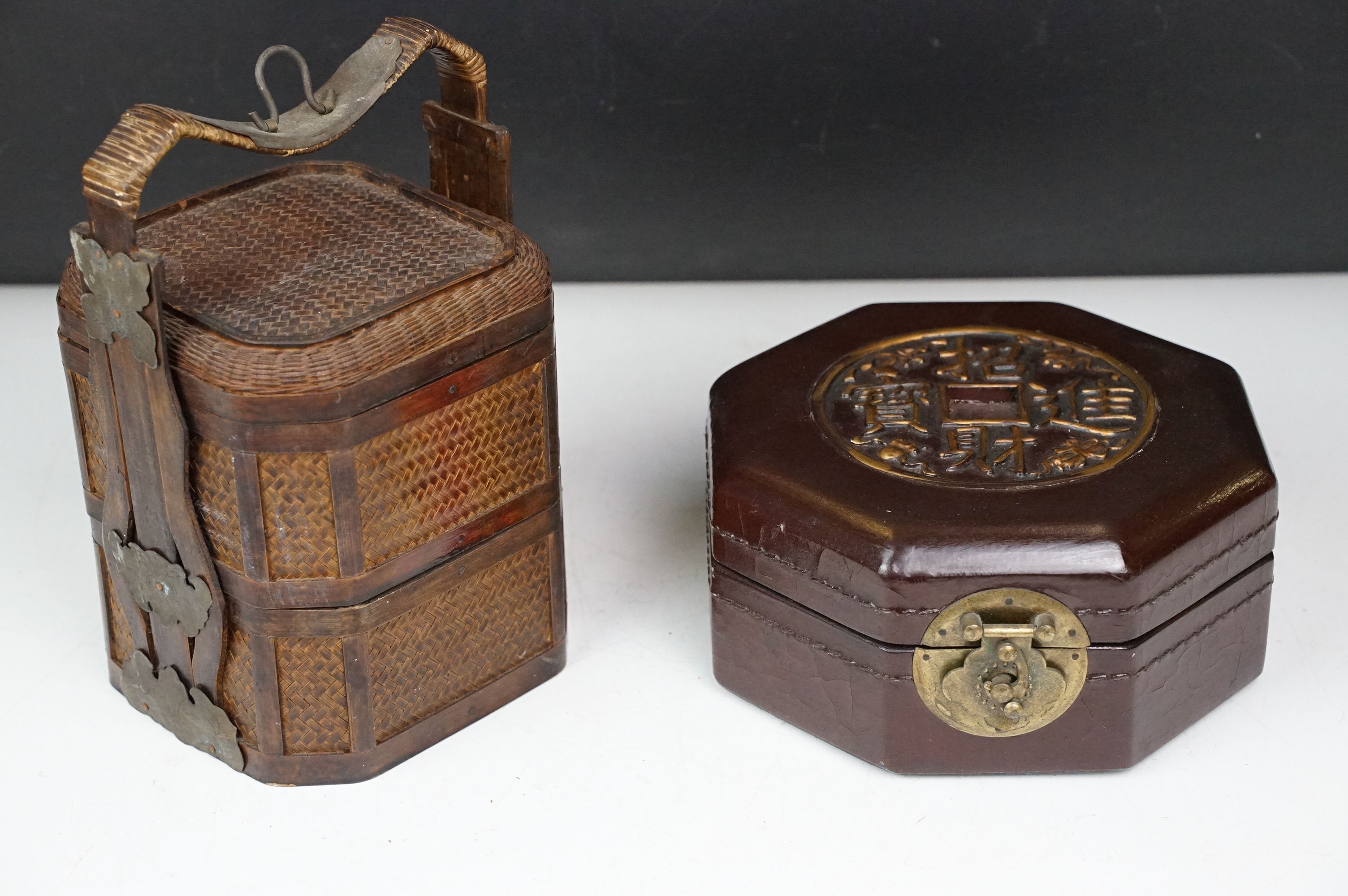Chinese octagonal wooden box with coin decoration to lid, together with a two-tiered woven lidded