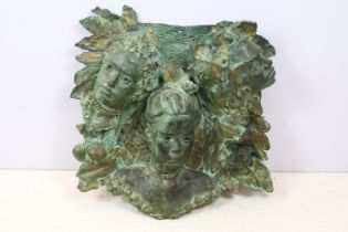 Fibreglass wall plaque depicting three figures amongst foliage, with verdigris effect finish, approx