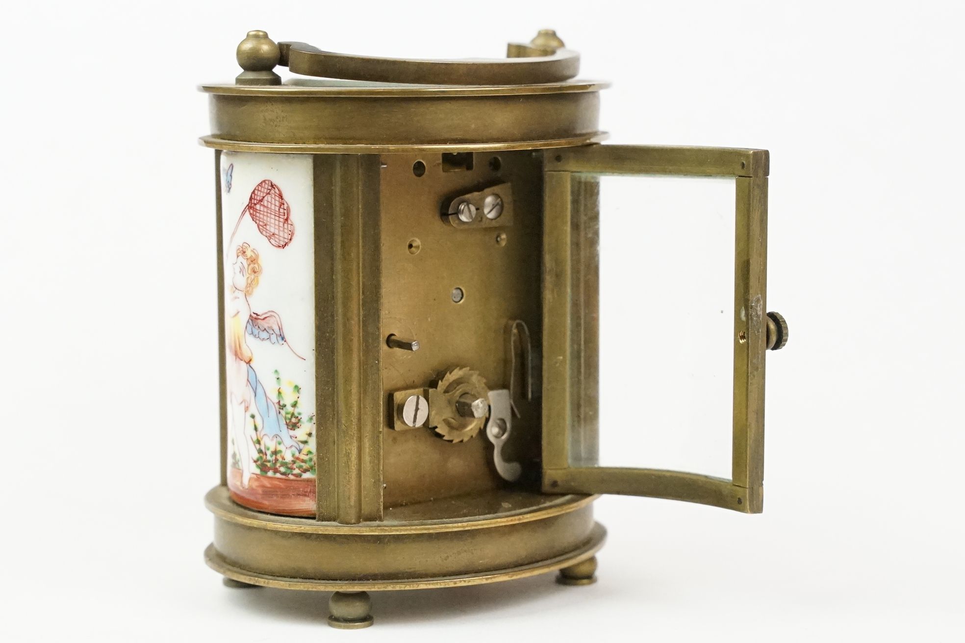 An antique French miniature carriage clock, brass cased with beveled glass panels, decorative Cherub - Image 9 of 10