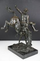 Bronze figure of a rodeo rider on a marble base after Frederic Remington, height approx 48cm