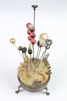 Collection of hatpins and stick pins and holder