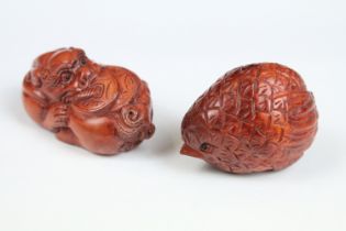 Two Chinese carved wooden Netsuke with one being in the form of a bird.