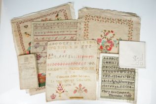 Group of five 19th century needlework samplers to include a sampler depicting flowers in a vase (