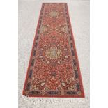 Super Keshan hand-made red ground carpet / runner of geometric design, approximately 350 x 90cm
