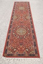 Super Keshan hand-made red ground carpet / runner of geometric design, approximately 350 x 90cm