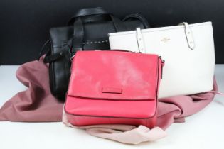 Two Radley handbags to include a black leather handbag and a pink example, both housed within pink