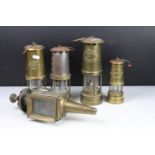 Group of four brass miners lamps to include E. Thomas & Williams Ltd, Ferndale Mining Co., etc (