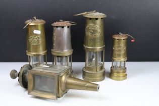 Group of four brass miners lamps to include E. Thomas & Williams Ltd, Ferndale Mining Co., etc (
