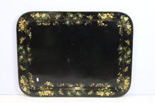 Large 19th century black lacquered papier mache tray of rectangular form with gilt decoration,