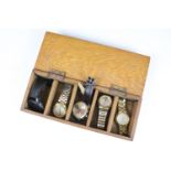 A collection of five gents wristwatches to include Seiko and Citizen examples within a wooden box