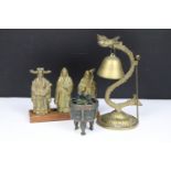 A collection of three brass Chinese ornaments to include figures and a table bell together with an