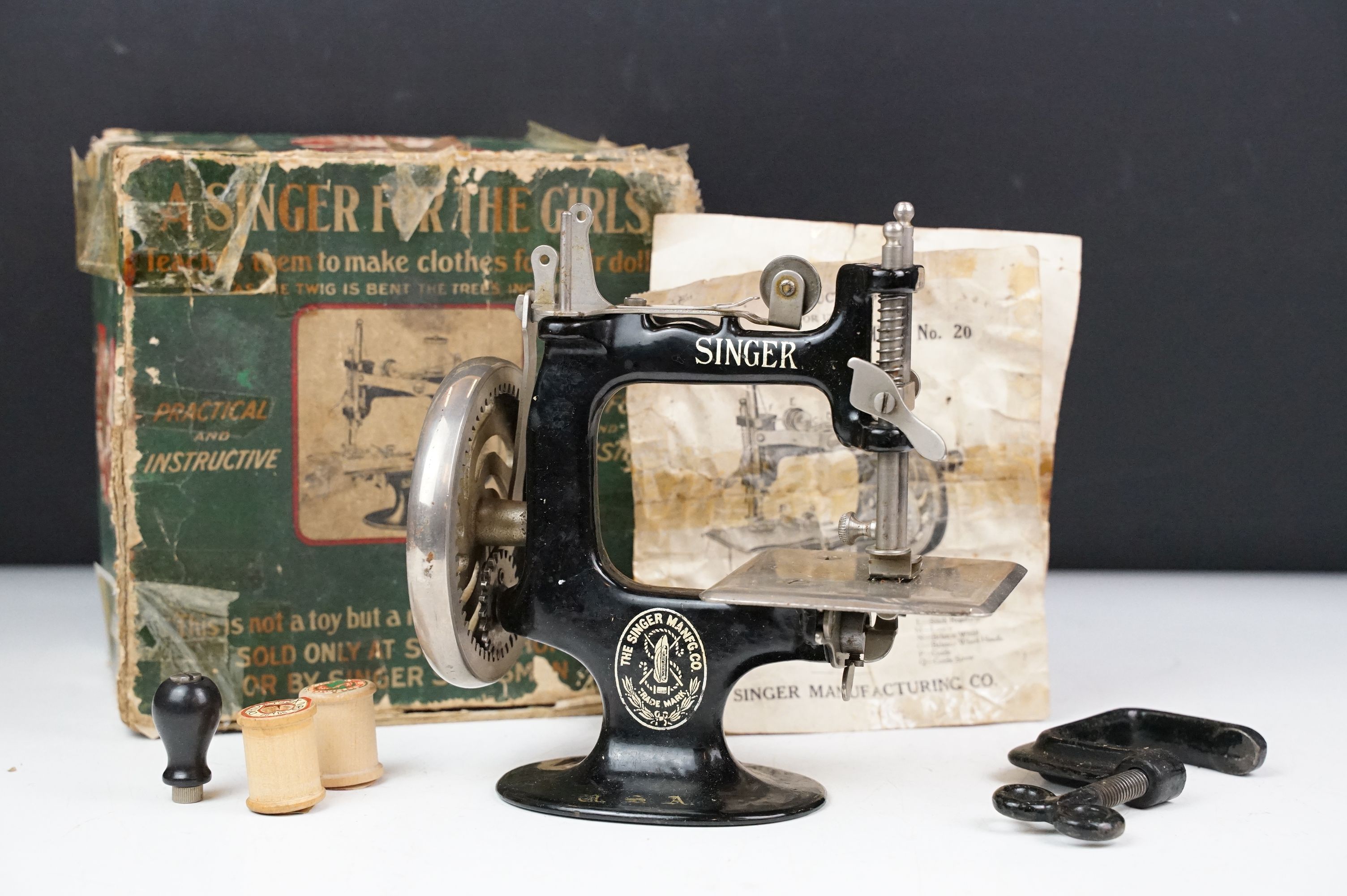 Early 20th century Miniature Singer Sewing Machine No. 20 with the original instruction leaflet