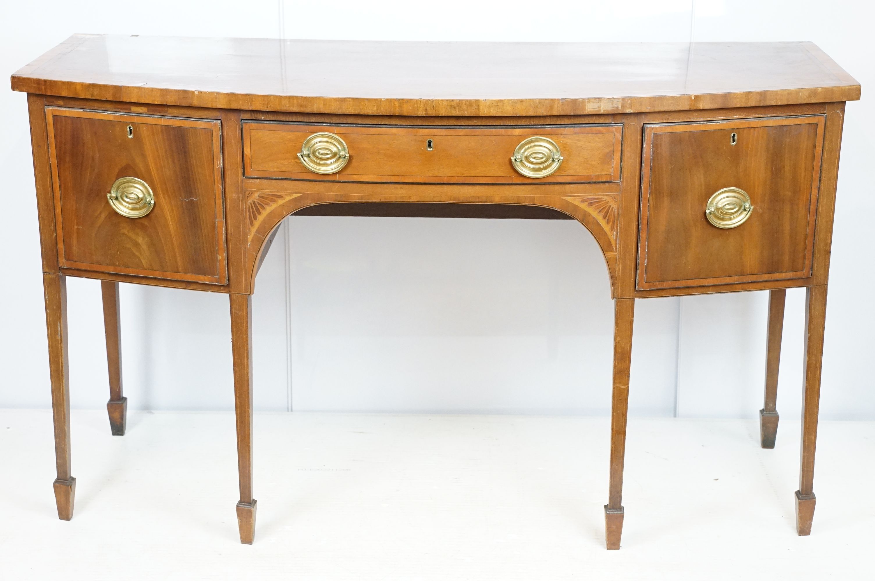 Edwardian mahogany inlaid bowfront sideboard, the central drawer flanked by two cupboard doors, on